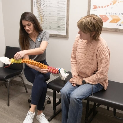 Dr Steview showing patient a spine model