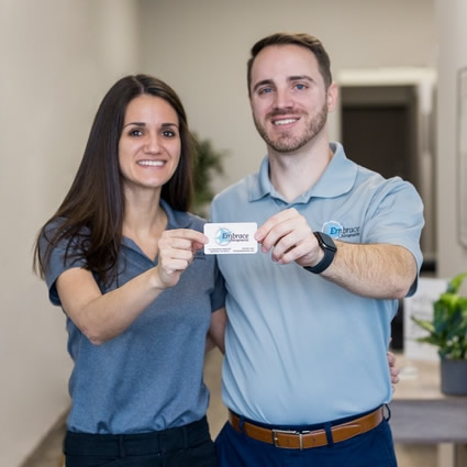 our doctors holding a business card