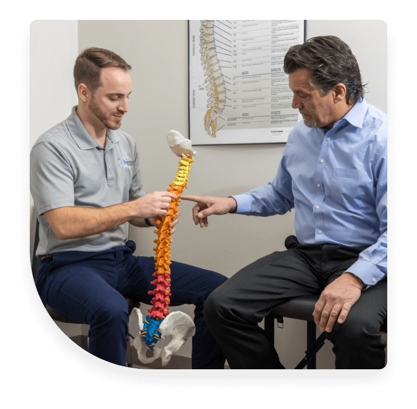 doctor showing patient spine model