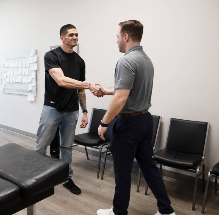 Chiropractor shaking patient hands