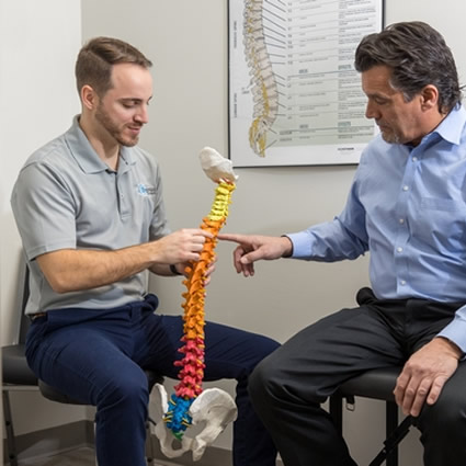 doctor showing patient spine model