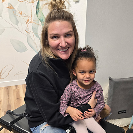 chiropractor holding smiling kid