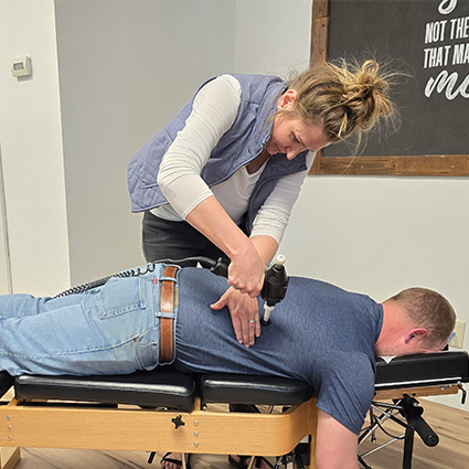 chiropractor adjusting persons back