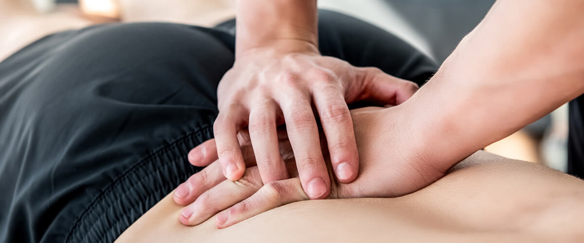 chiropractor adjusting persons back