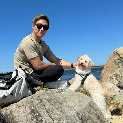 Dr Feng at beach with puppy