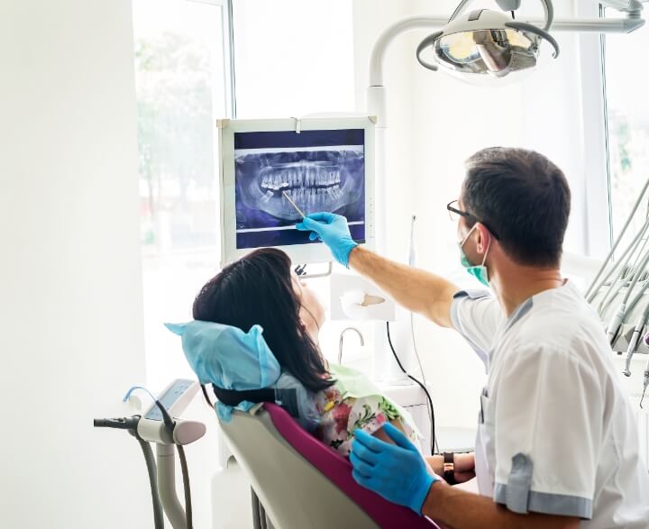 Dentist and patient checking xray