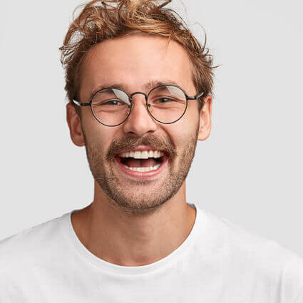 man with round glasses and open smile