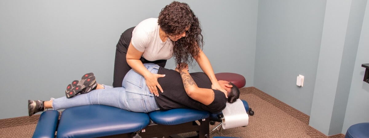 McKinney chiropractor adjusting patient's lower-back