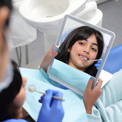 child patient looking in mirror