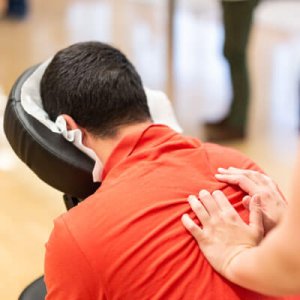 man in red shirt seated back massage