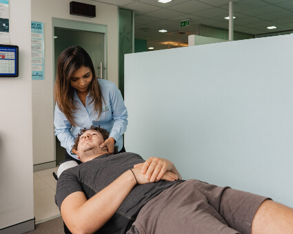 adjusting patient's neck