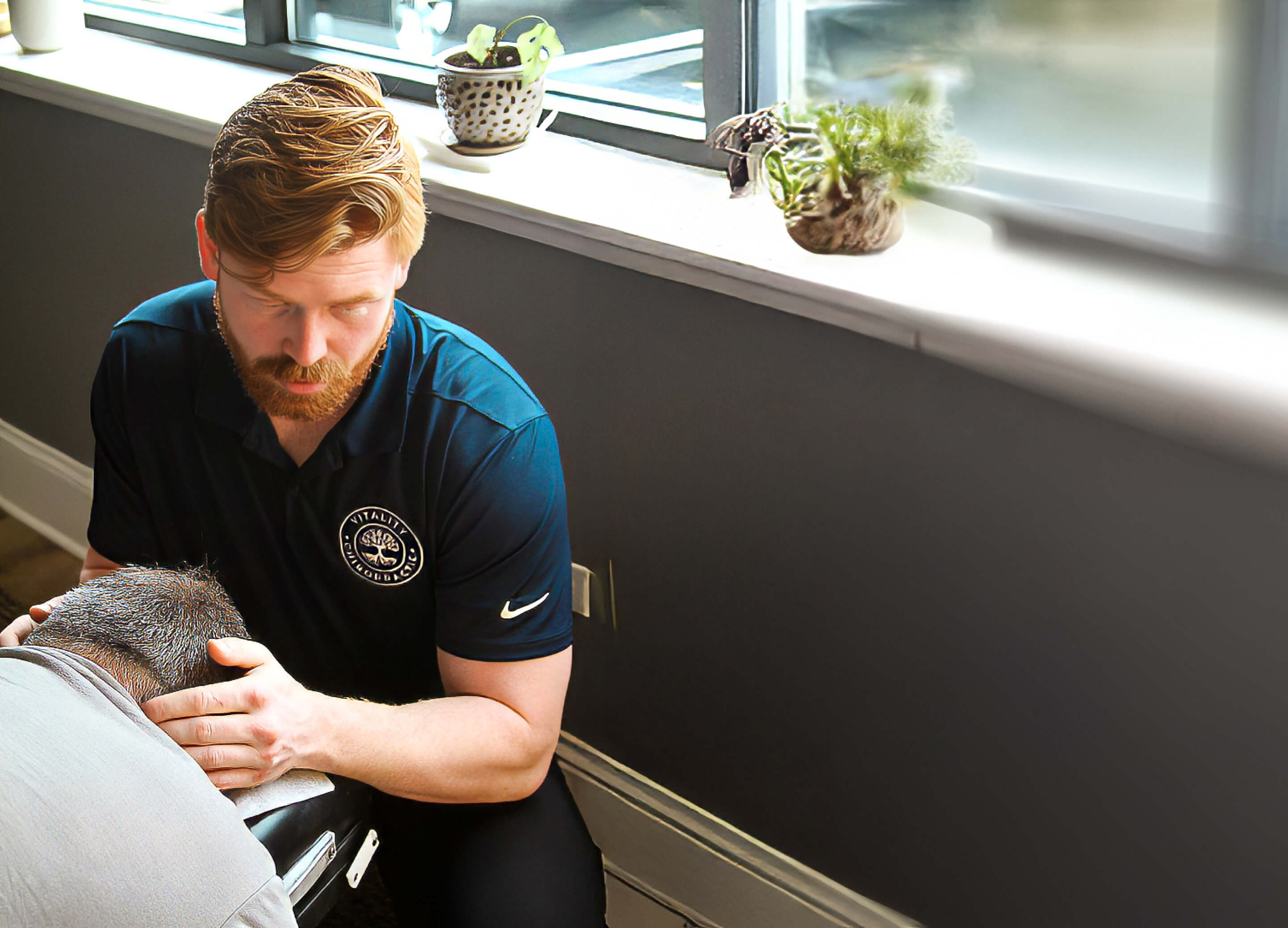 Chiropractor adjsuting patient's neck