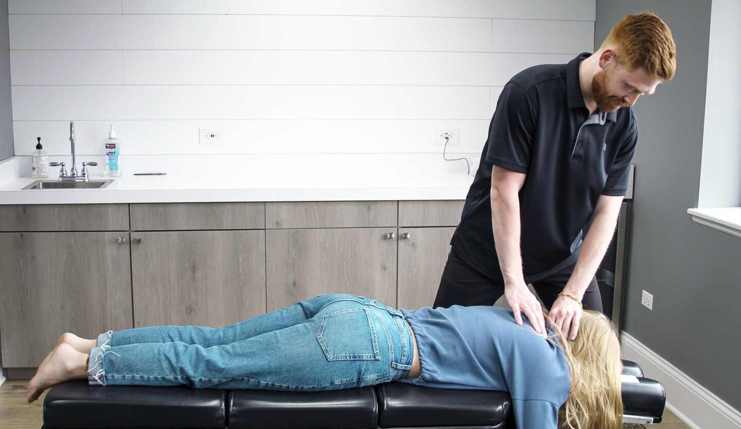 Chiropractor adjusting patients back