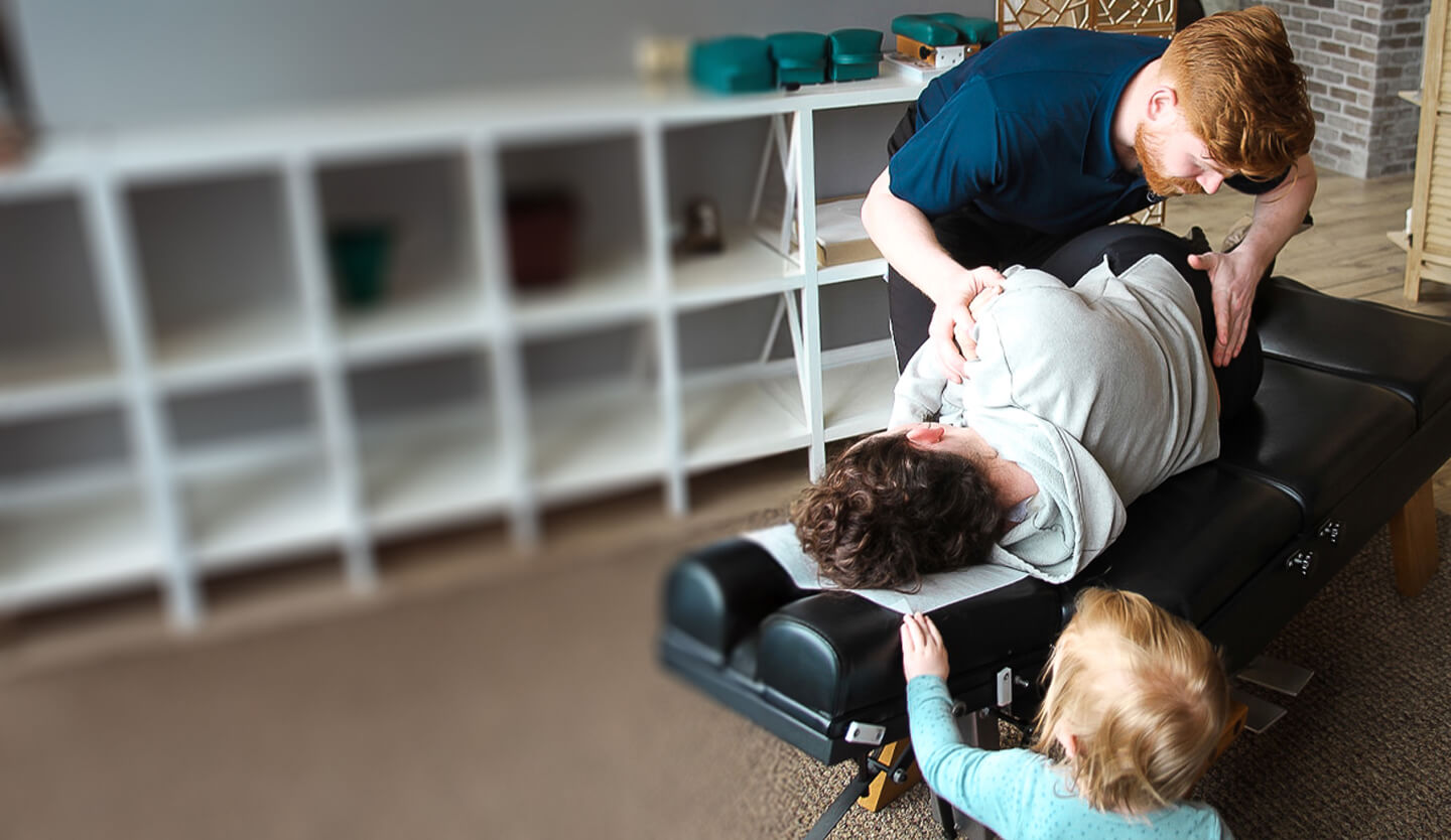 Chiropractor adjusting patients back