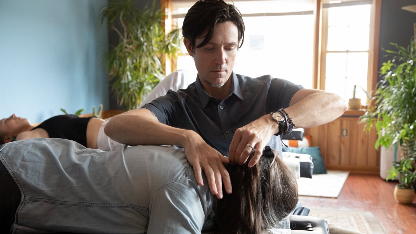 Chiropractor adjusting patient