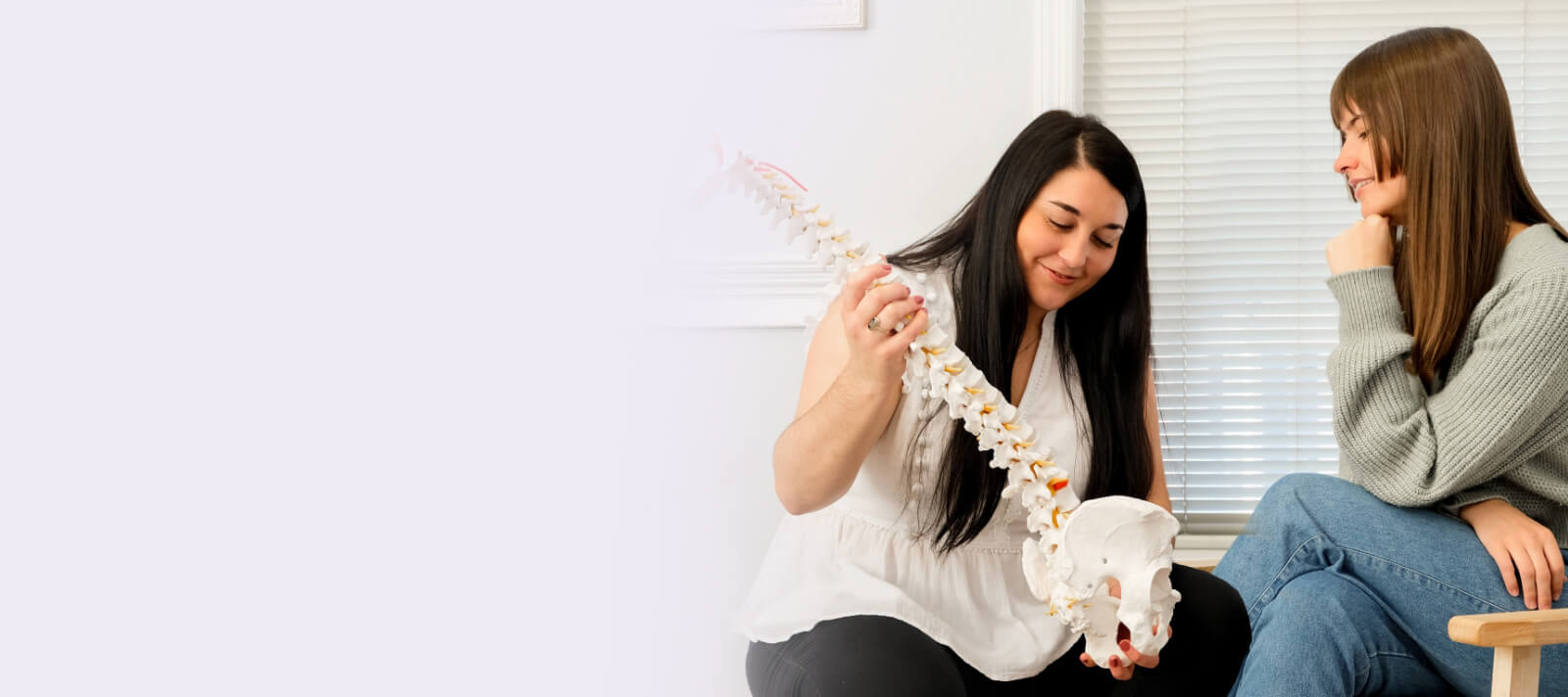 doctor holding spine model