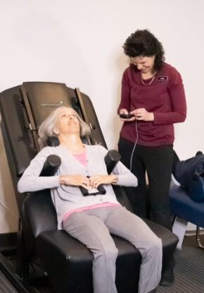 Female patient sitting on a chiropractic chair 