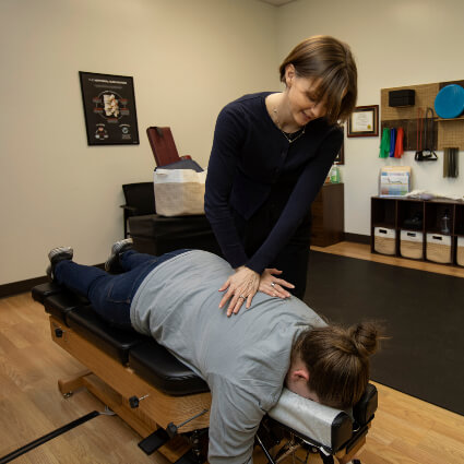 Dr Annamarie adjusting woman's back