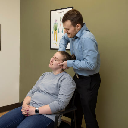 Dr Logan adjusting man's neck