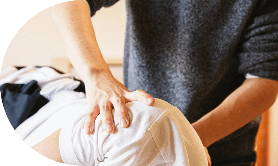 male chiropractor adjusting patient's shoulder