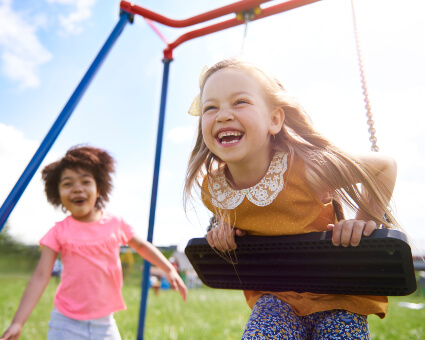 Girls playing on swing