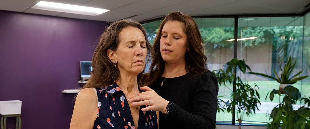 Doctor touching patients neck