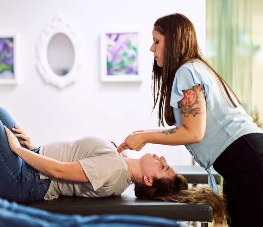 Chiropractor adjusting patients chest