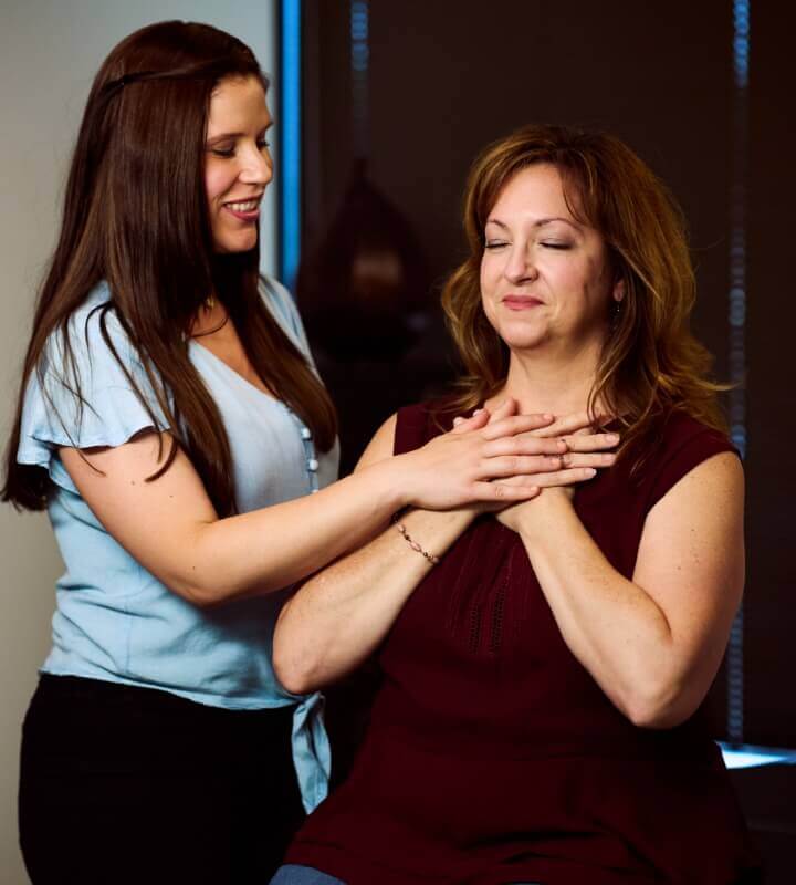 Chiropractor touching patients chest