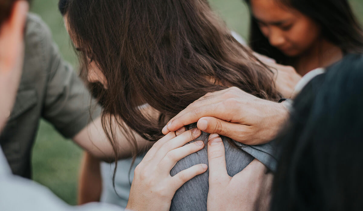 woman-held-by-group