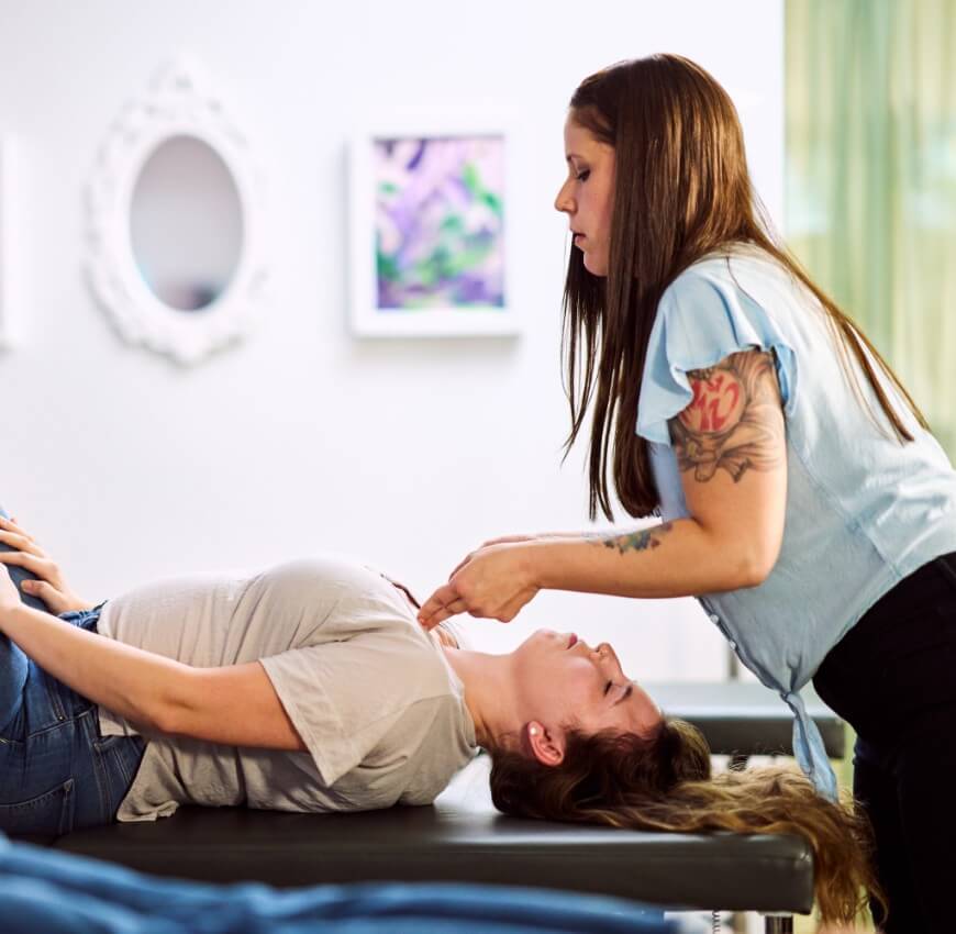 Chiropractor adjusting patients chest