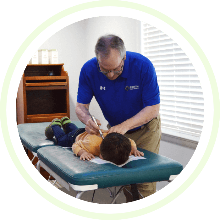 Dr. Gregory adjusting kid patient