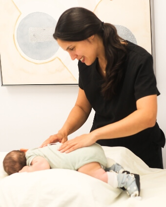 Baby receiving a back adjustment