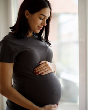 pregnant-mama-standing-by-window