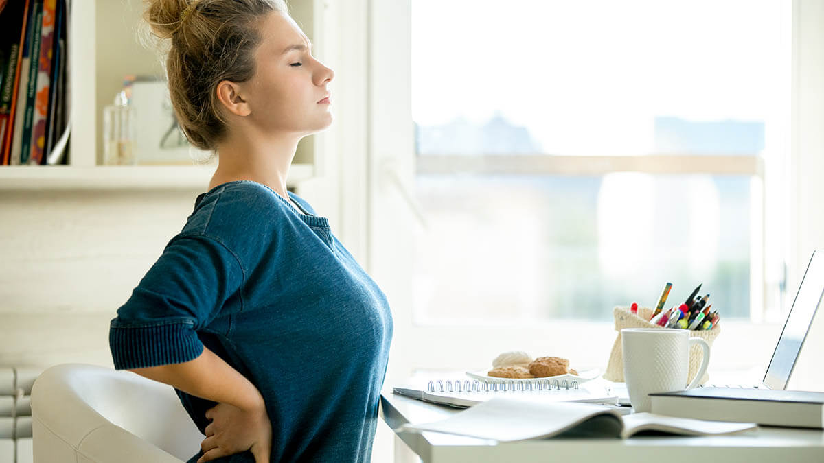 Woman sitting by desk