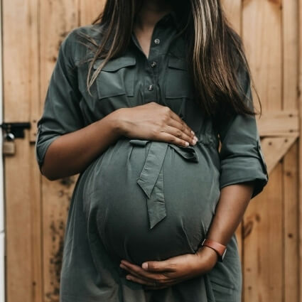 pregnant person with hands on stomach