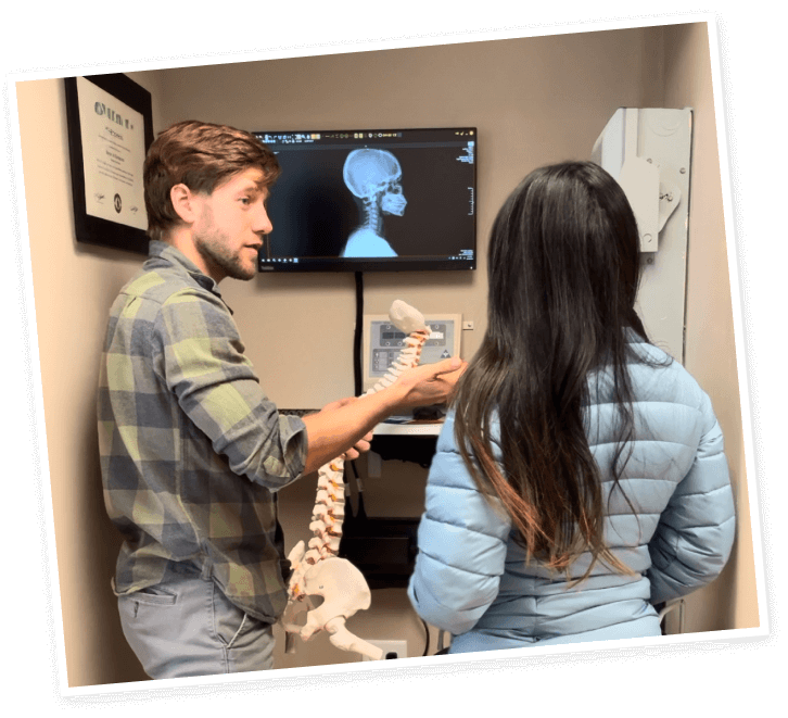 Colorado Springs Chiropractor Dr. Peter Harris holding spine model
