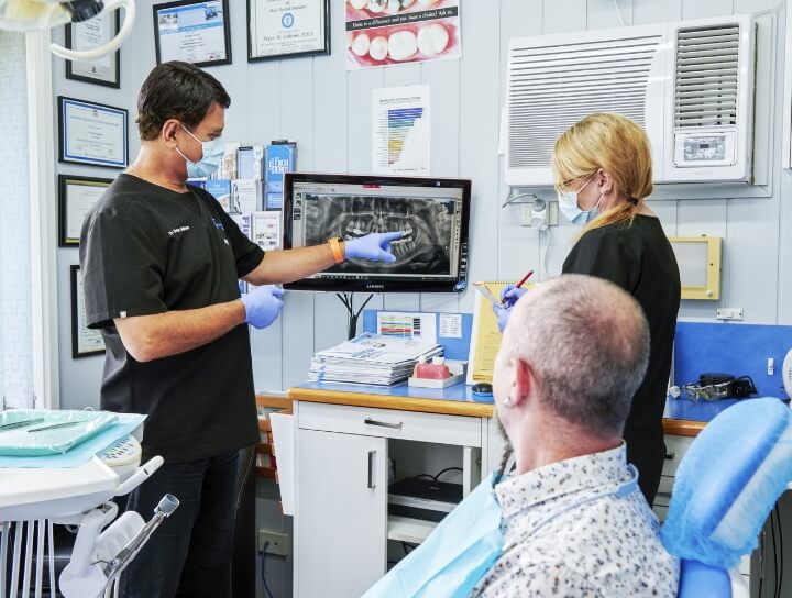 Dentists and patient checking the xray