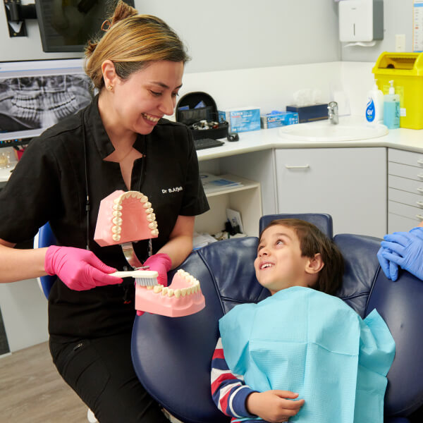 Dentist checking girl patient