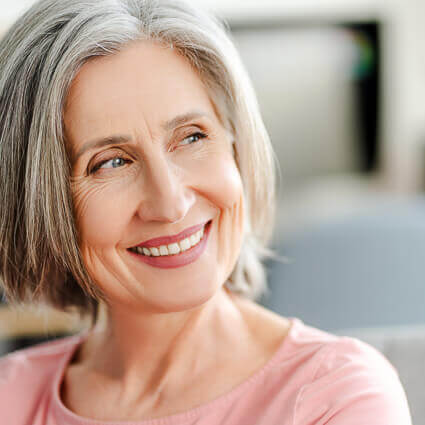 woman looks sideways smiling 