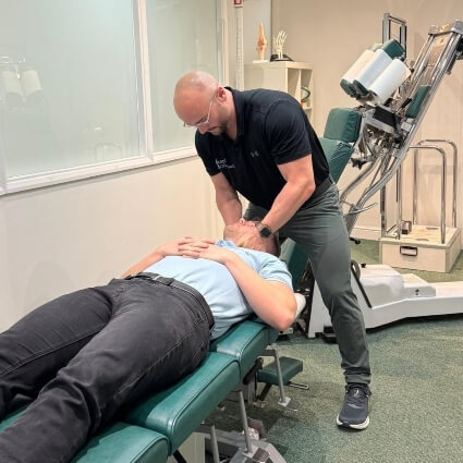 doctor adjusting patients neck