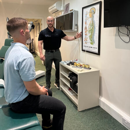 York chiropractor in discussion with his patient