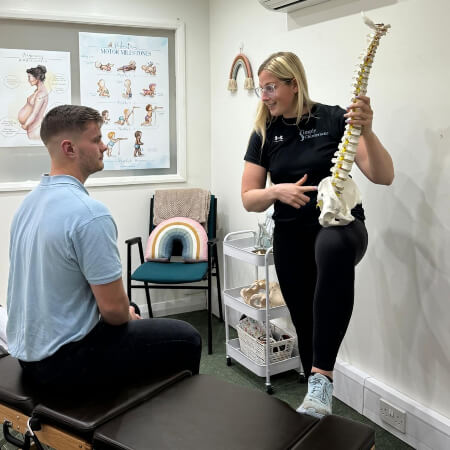 York chiropractor pointing at a spine