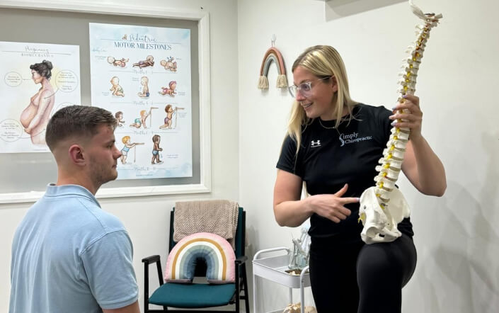 Chiropractor explaining to patient