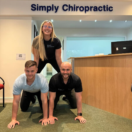 Simply Chiropractic team posing for a silly photo