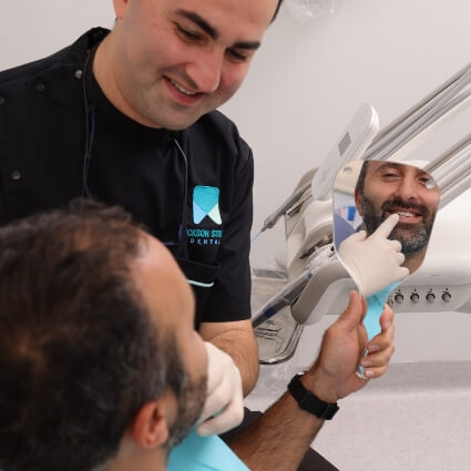 Dr Arik looking at patients teeth