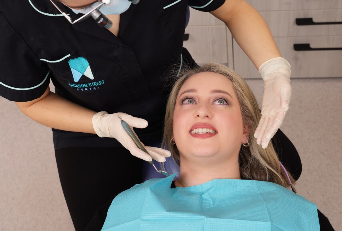 Checking woman on dentist chair