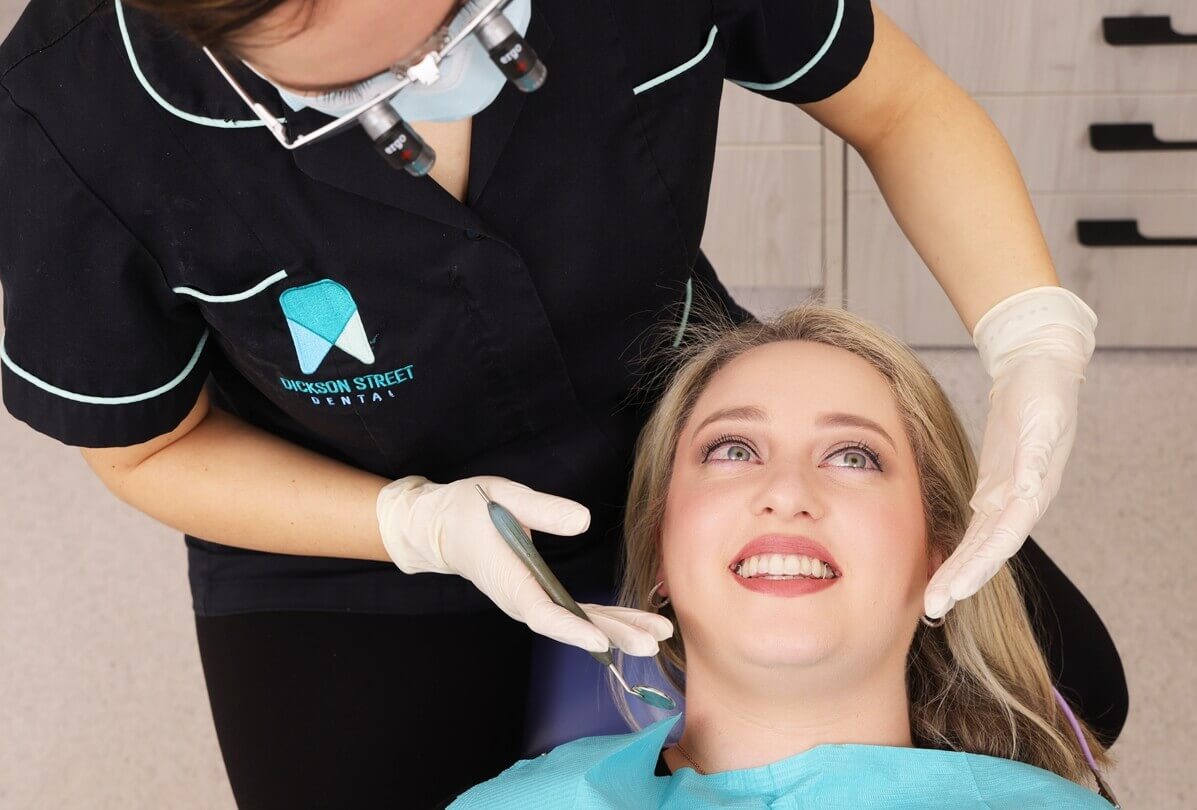 Checking woman on dentist chair