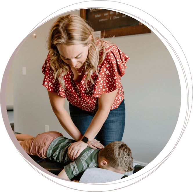 Chiropractor adjusting boy