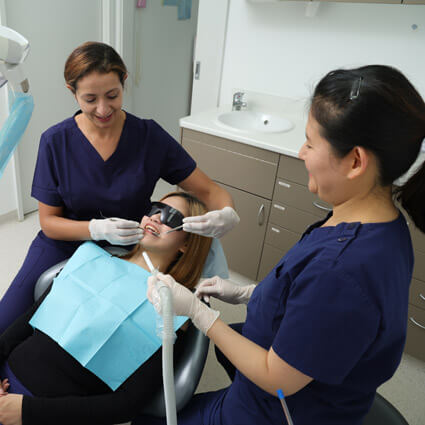 staff and dentist with patient