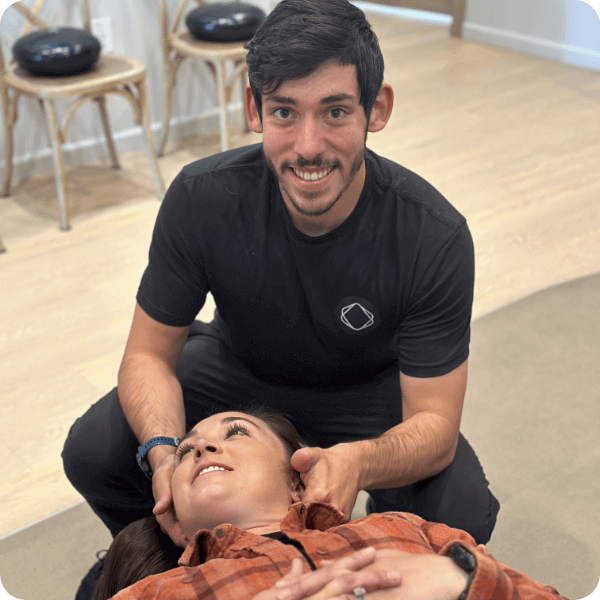 Dr. Daniel adjusting female patient's neck